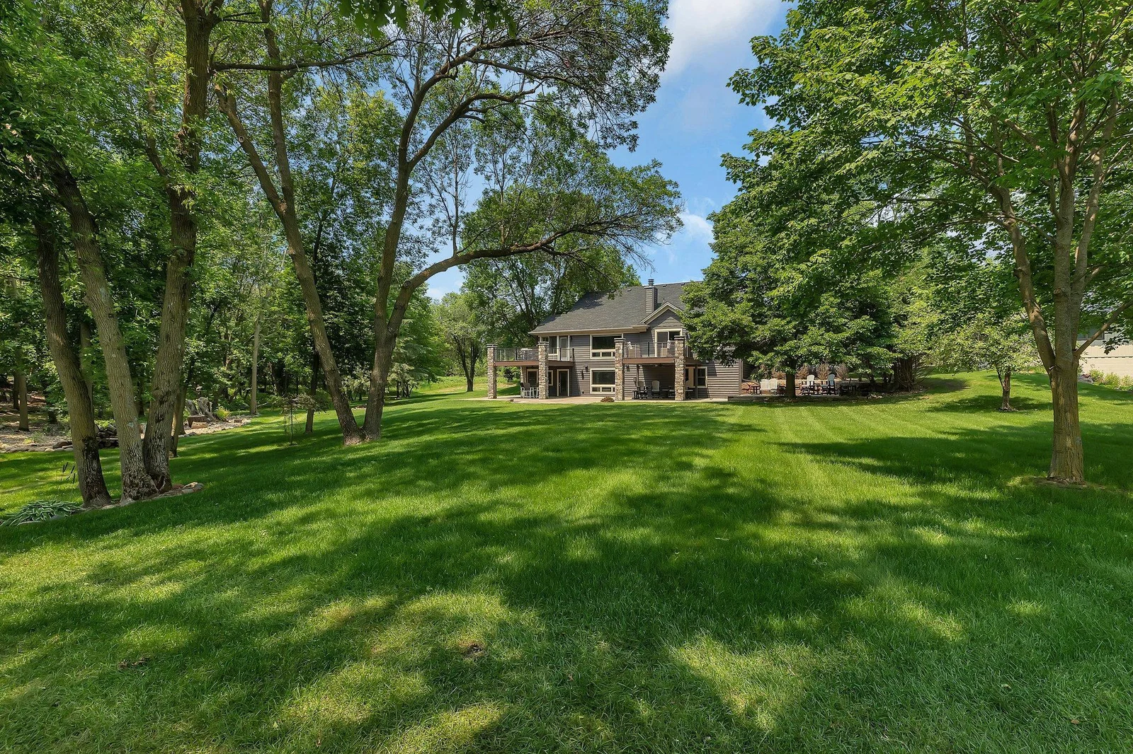 Gently sloping lawn to sandy beach and water.