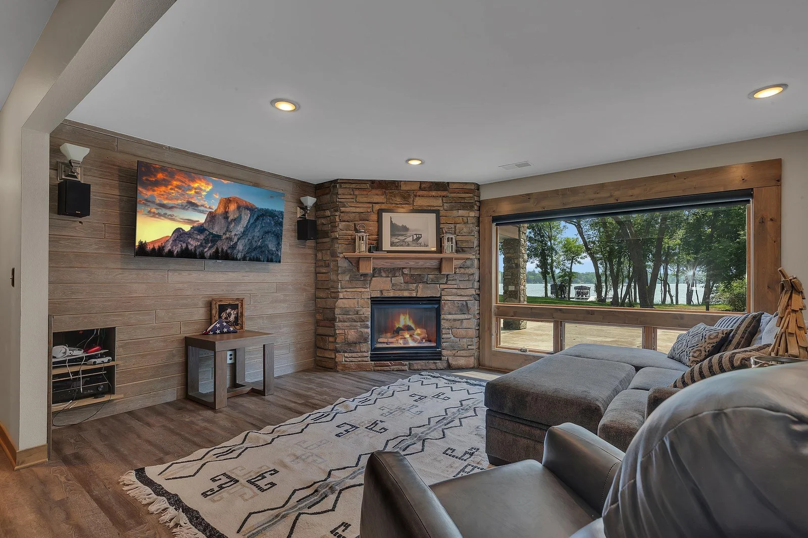 Bright, open living room with fireplace and water views.