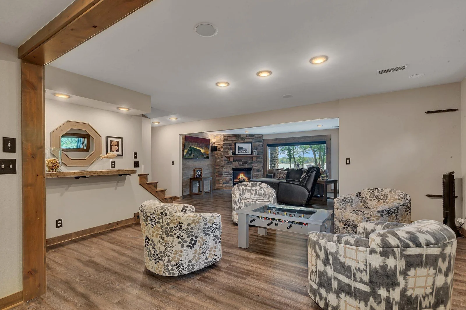 The lower level offers a comfortable sitting area complete with a wet bar and space for game tables—perfect for entertaining