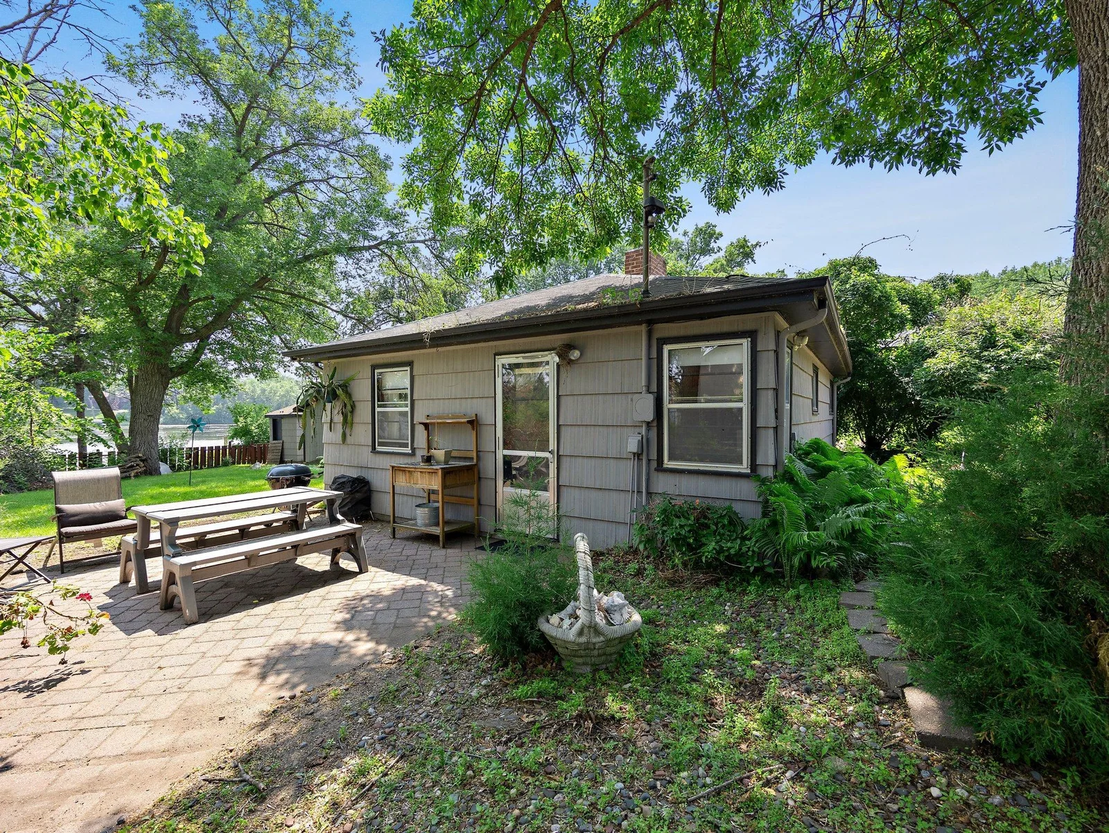 A beautifully maintained guest house sits on the property, ideal for hosting visitors or potential rental income. Just outside the guest house, enjoy a 15' x 12' concrete patio with peaceful lake views—an ideal spot for morning coffee.