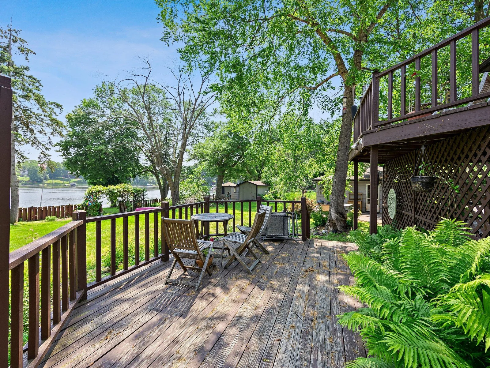 The outdoor spaces are a true highlight. A two-tiered wooden deck offers expansive areas for relaxing, grilling, or entertaining.