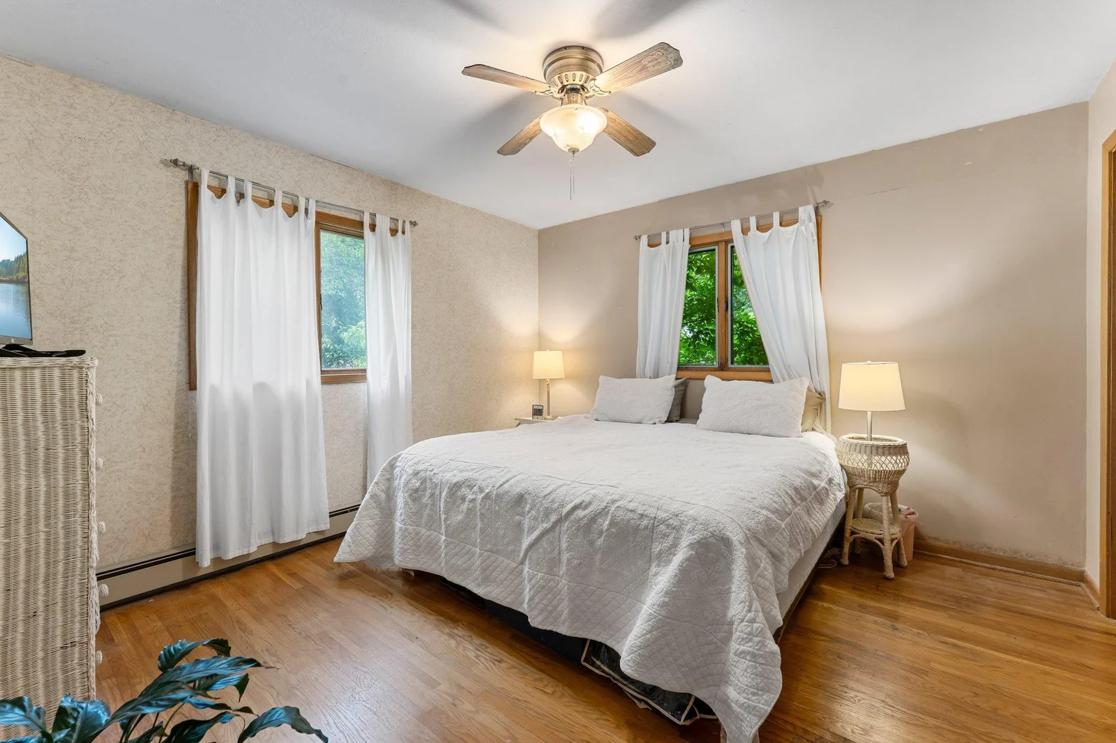 Two comfortable bedrooms are located on the main level—one with hardwood floors, the other carpeted for added coziness.