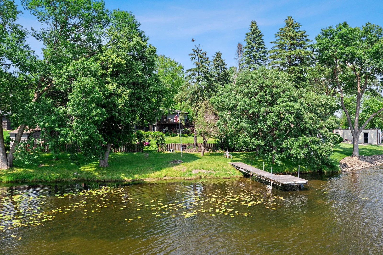 An in-ground irrigation system draws from the lake to maintain the lush landscape, which even includes established asparagus and horseradish plants.