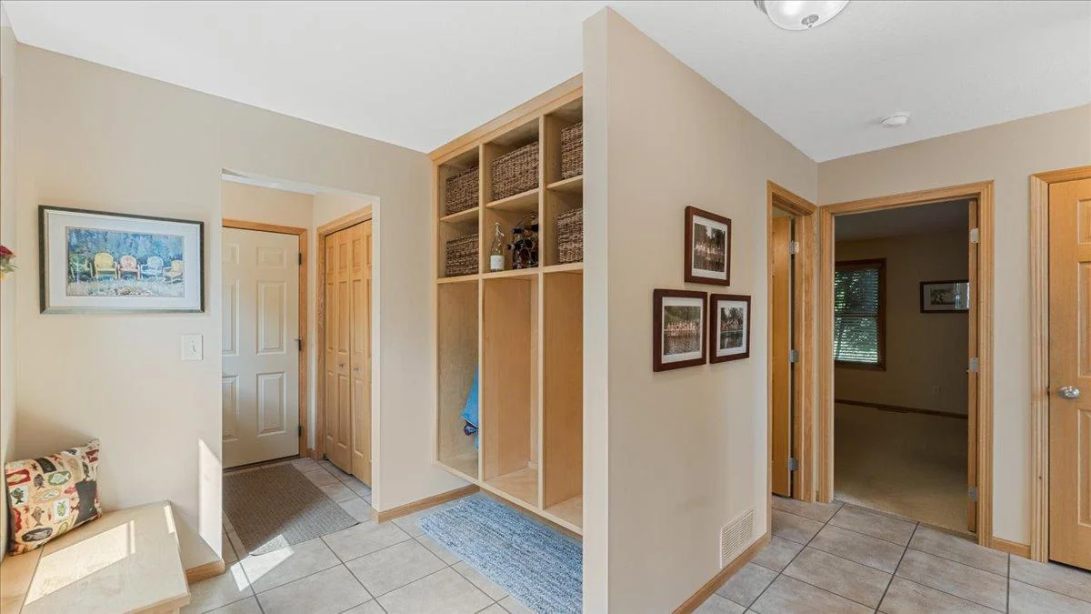 4132 Omaha Lane NW, Alexandria, MN 56308 Mud room with a utility sink and open shelving and closet storage space, easy access to the garage.