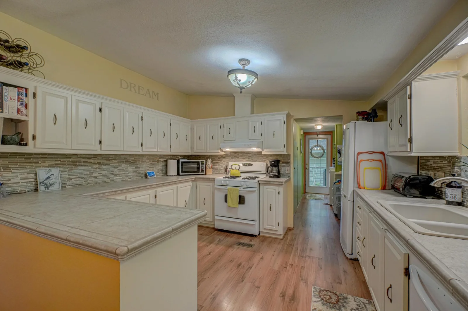 Cooking is a breeze in the generously sized kitchen, featuring abundant counter space and ample cabinetry for all your culinary needs