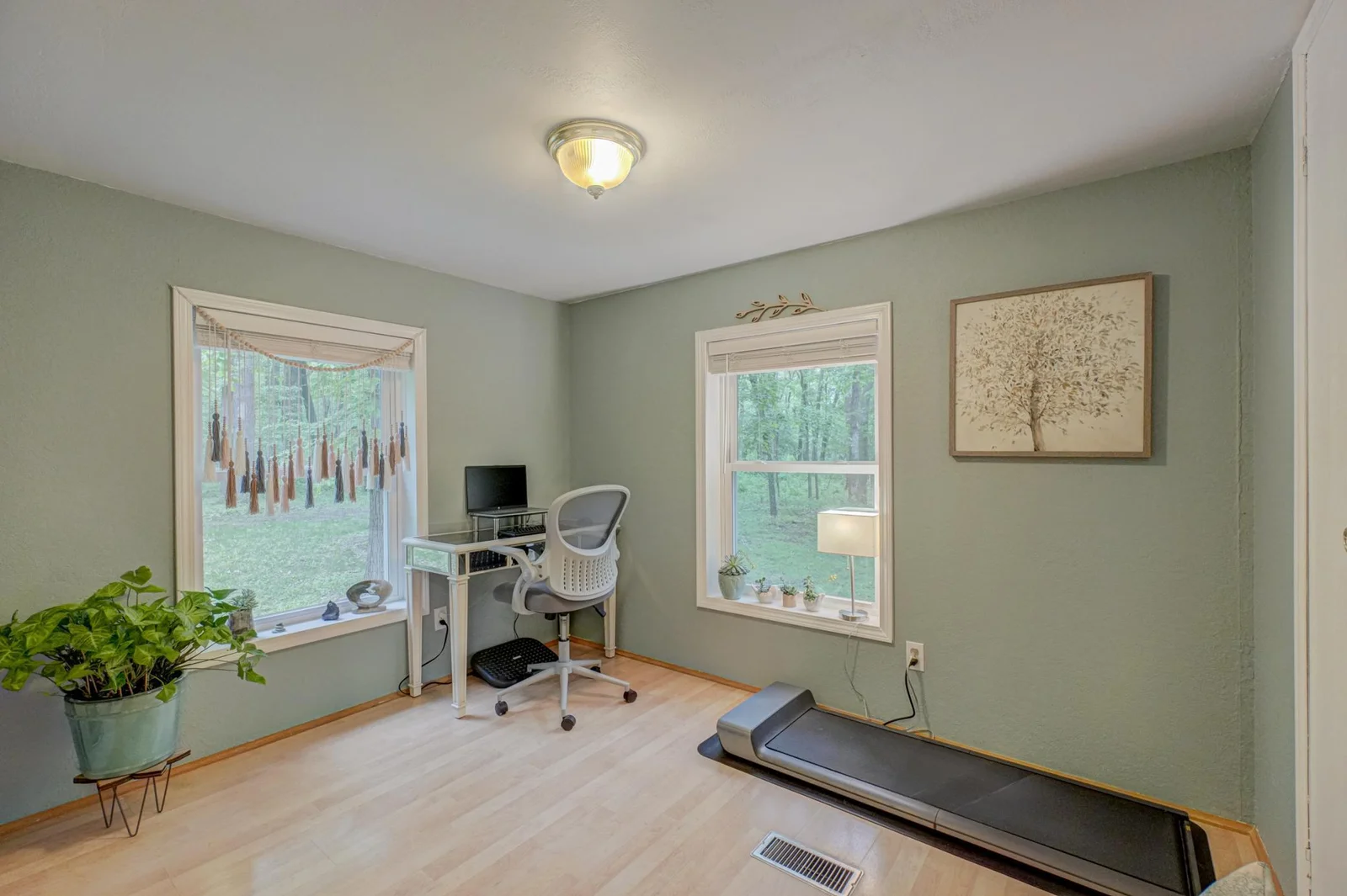 A third main-level bedroom offers flexible space—perfect as a guest room, home office, or cozy recreation room to suit your lifestyle