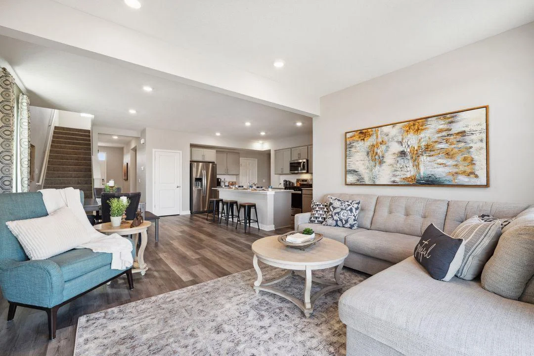 A view from the living room into the dining area and kitchen.  Phot of a previously staged model...