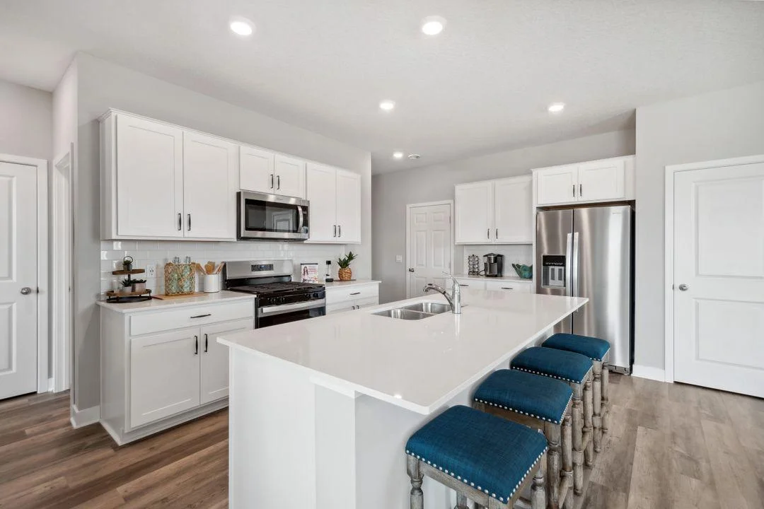 This beautiful kitchen has plenty of countertop and storage space!  Photos are of a previously staged model.