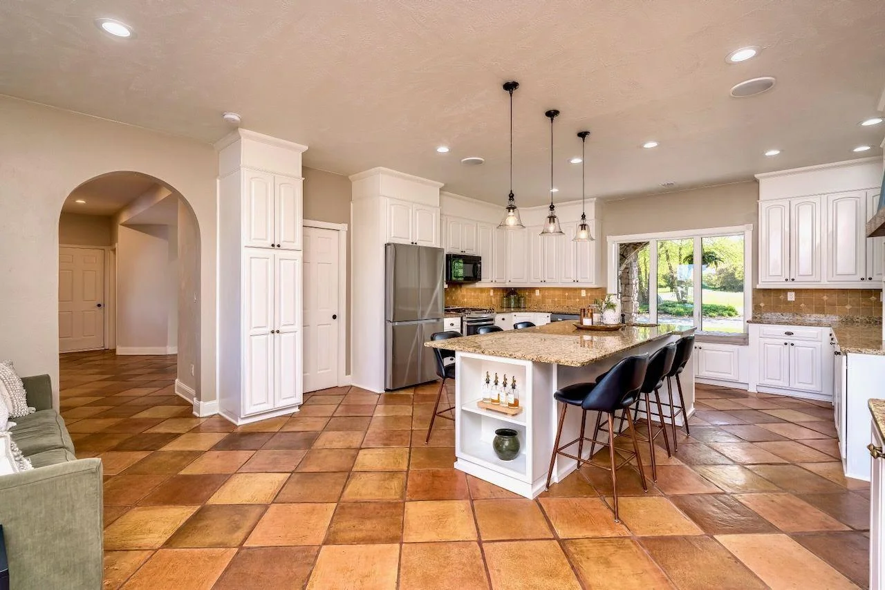 Gourmet kitchen with SS appliances, granite countertops and custom cabinetry