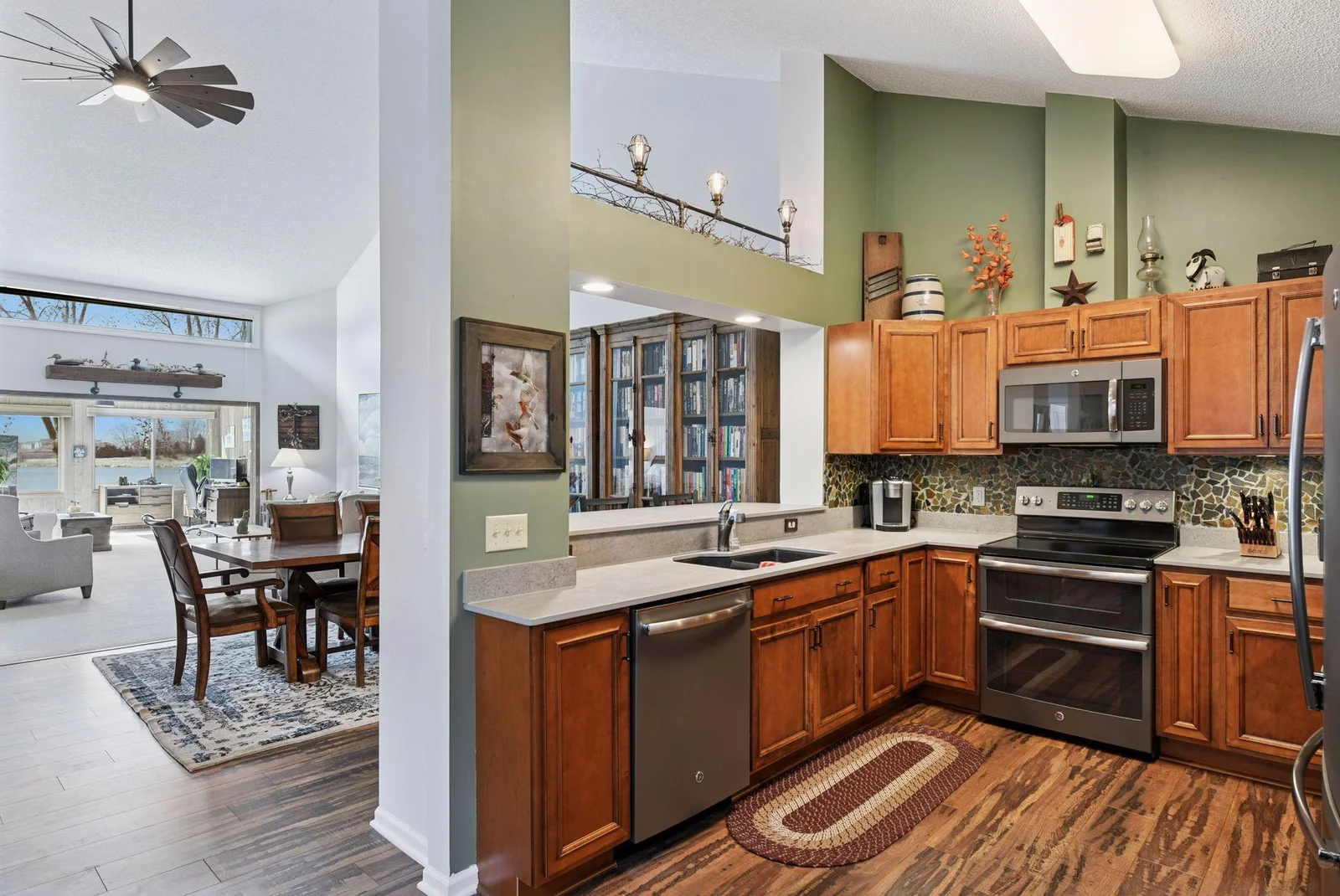 Enjoy open sightlines that seamlessly connect the kitchen, dining, living room, and sunporch.