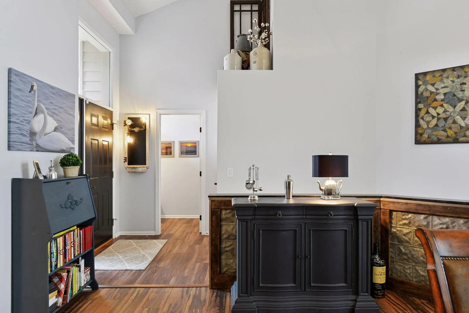 A welcoming two-story entryway offers a convenient half bath and a roomy front closet for coats, boots, and everyday essentials. Buyers will appreciate the charming half wall adorned with metal and wood accents, adding unique character to the space.
