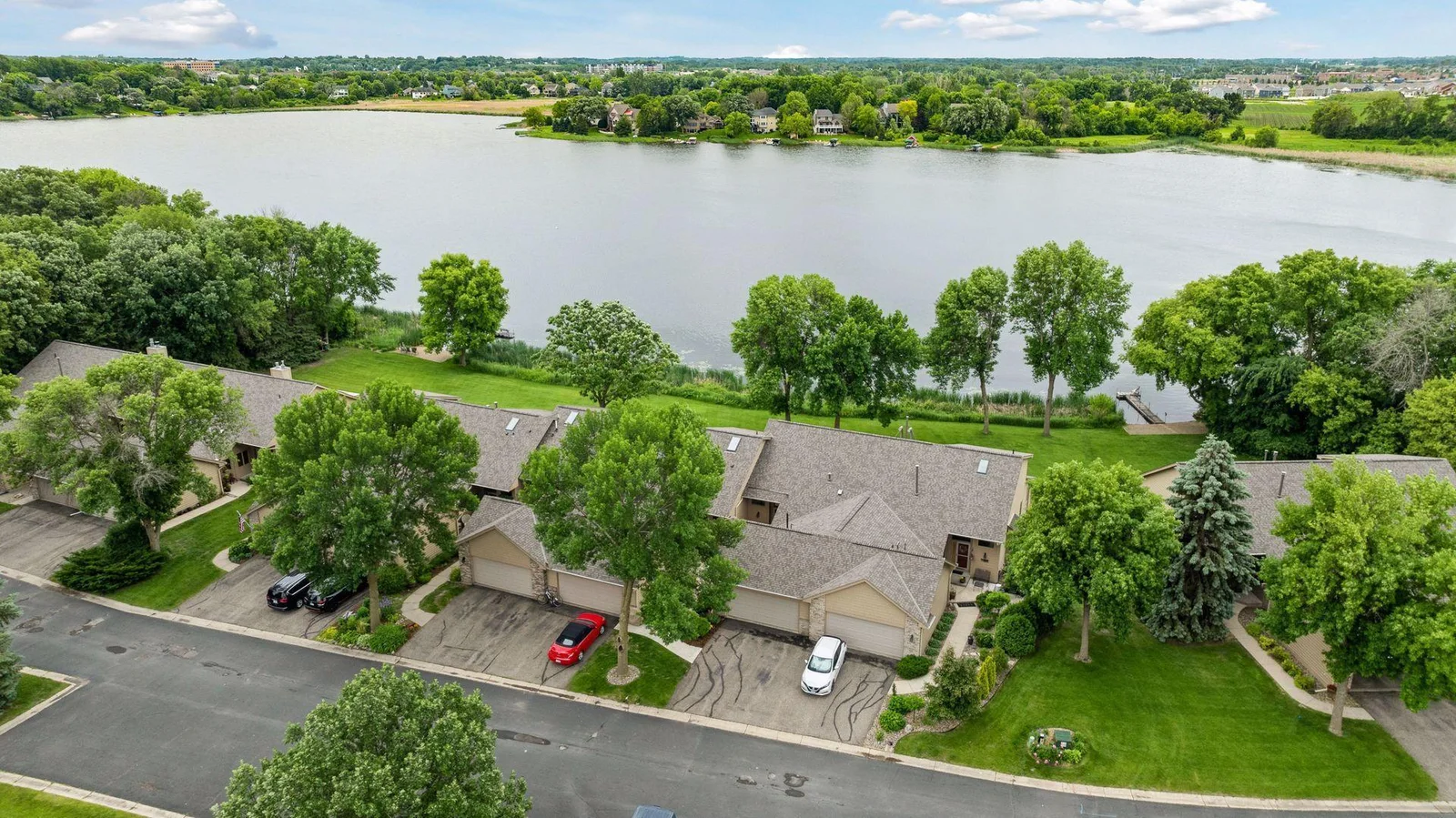 Hard to find main level living with ultimate privacy that backs to lake front on full recreational Burandt Lake! Stunning interior updated throughout.