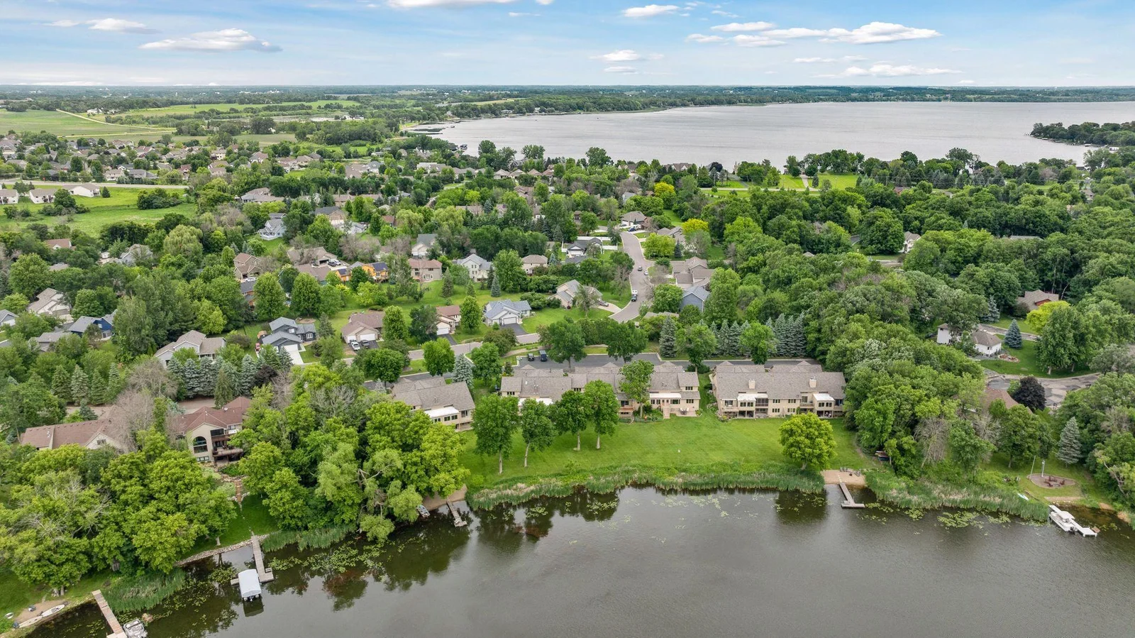 Aerial view of Waterbury townhomes with flat backyard to enjoy year round along with steps to Lake Waconia and paved trail systems.