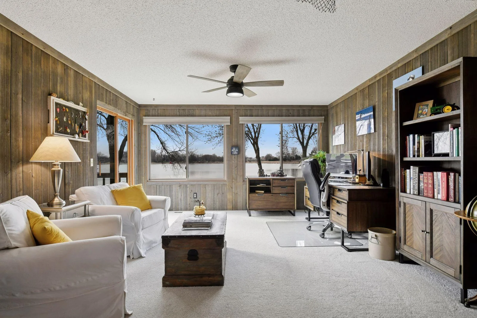 Relax in the sunroom and office area that opens to the deck—perfect for taking in the calls of loons and the soothing sounds of nature.