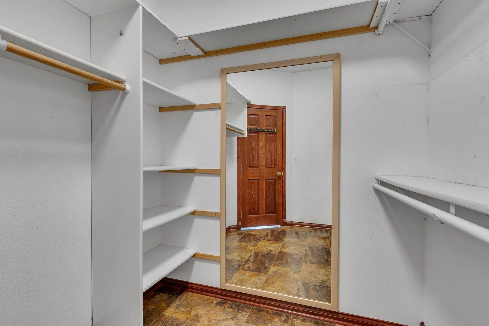 Primary bedroom walk-in closet