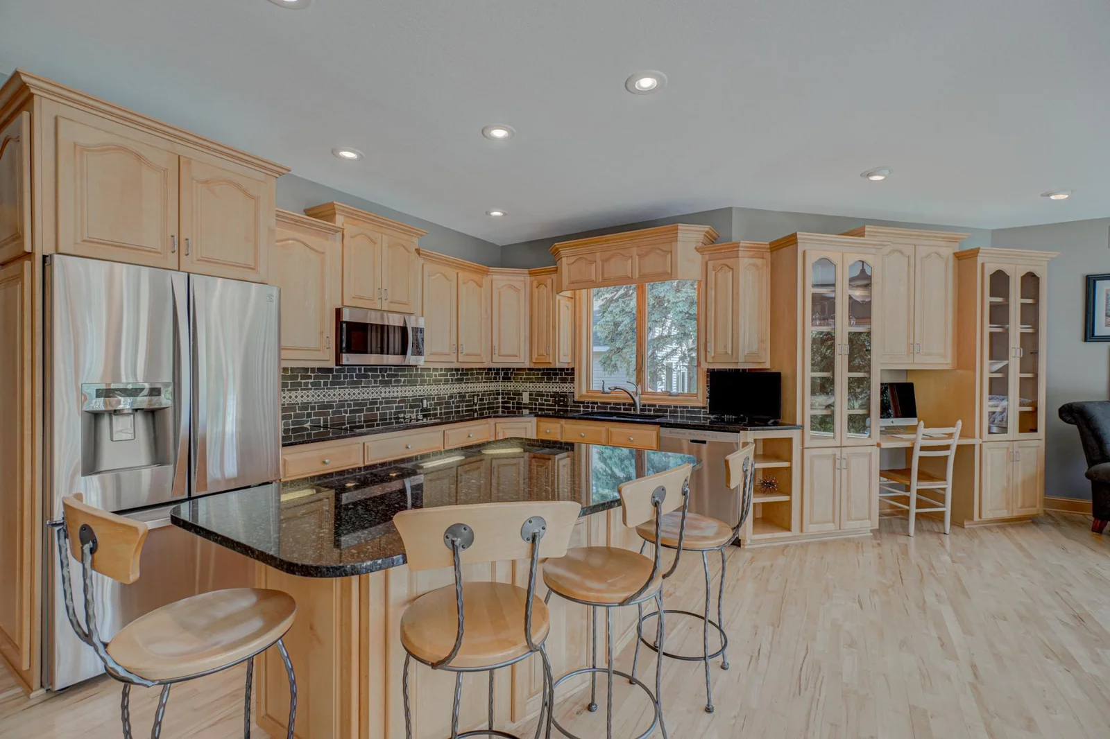 The kitchen and utility areas are equally functional and well-appointed, including a spacious laundry room with ample cabinet storage.