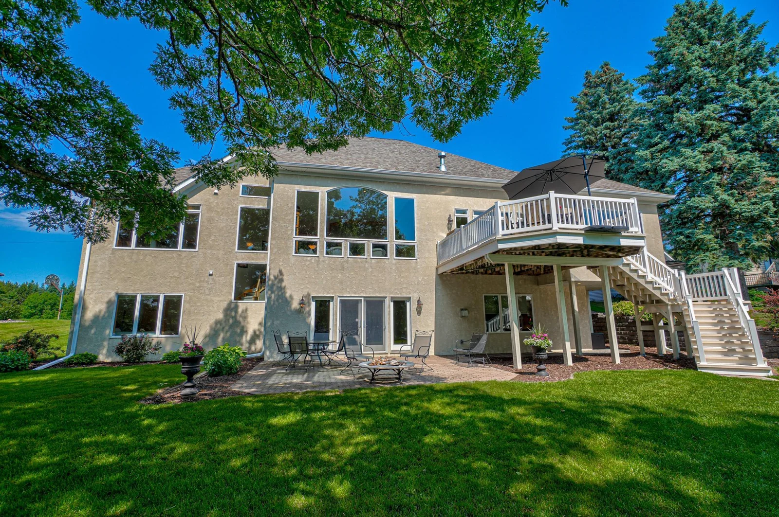 Thoughtfully designed to capture the beauty of its surroundings, the home boasts expansive windows throughout, flooding the living spaces with natural light and offering breathtaking views of the lake.