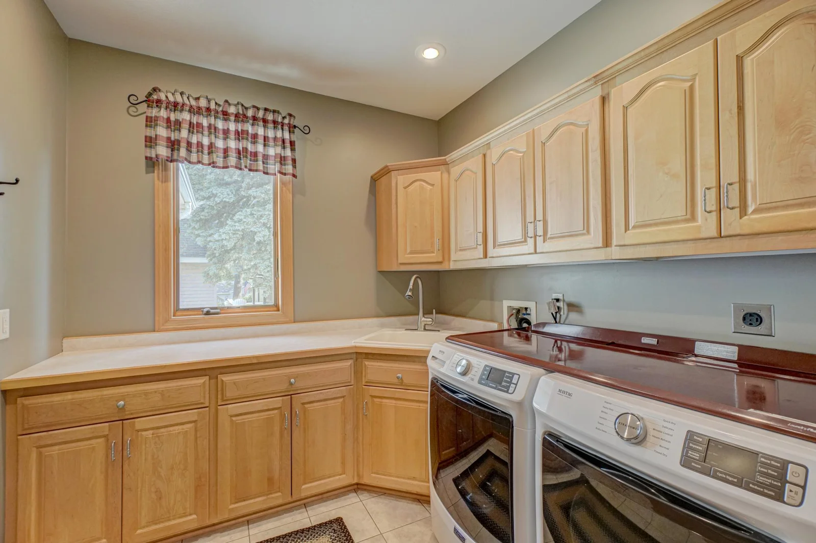 Spacious laundry room with plenty of storage.