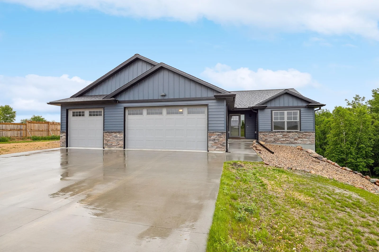 The main level includes two bedrooms and a stylish bathroom, while the walkout lower level offers two more bedrooms, a full bath with heated floors, and a spacious family room.