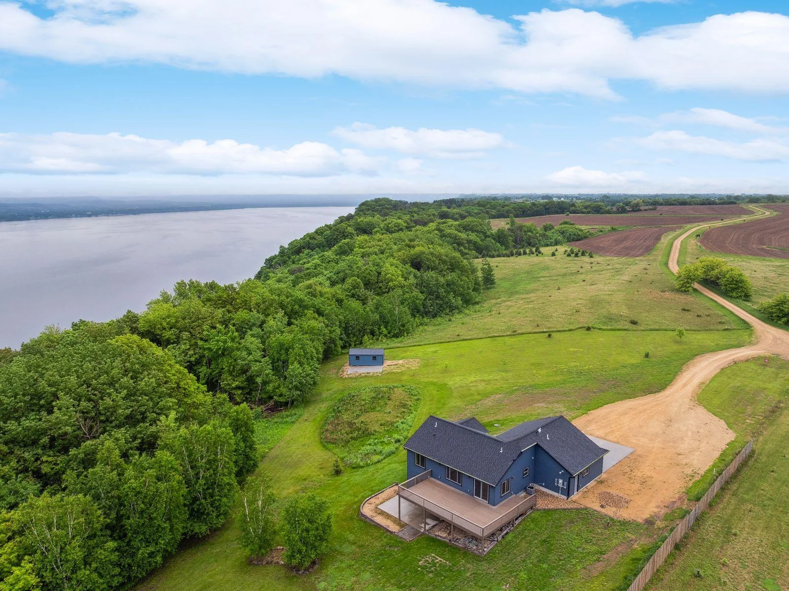 Perched on one of Lake City’s rare blufftop points, this stunning 2023 custom-built home offers panoramic views, ultimate privacy, and luxury finishes throughout.