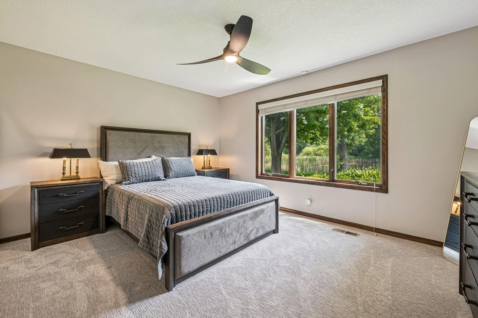 Spacious lower level bedroom with large windows facing the pond.