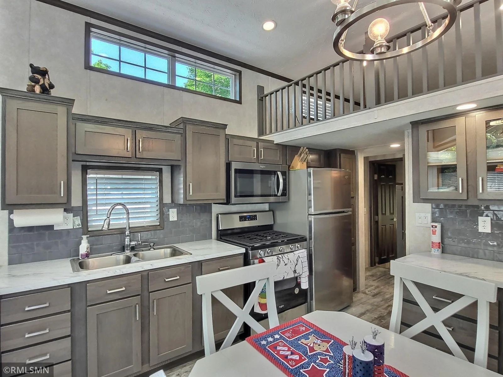 Easy cleaning with vinyl plank flooring that runs throughout this area of the park model.