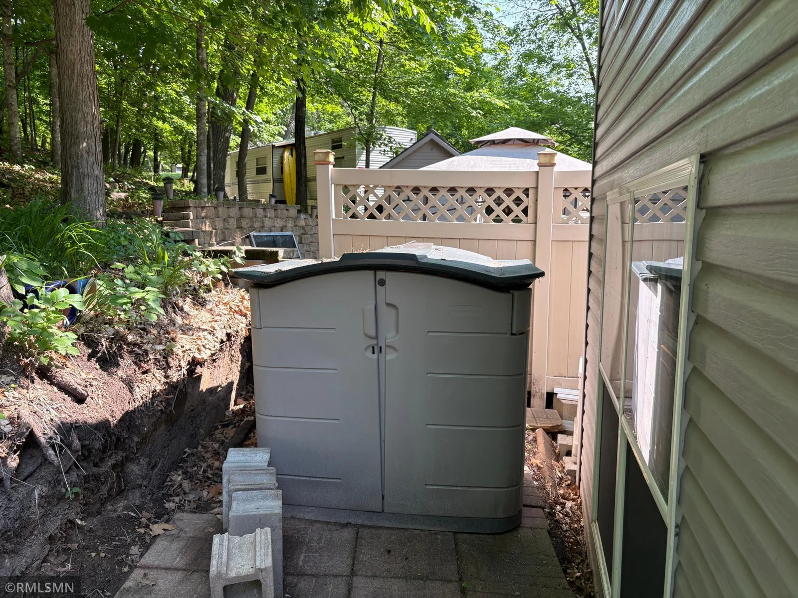 There are couple of storage containers that will remain with the property. Seller will be redoing the back retaining wall.