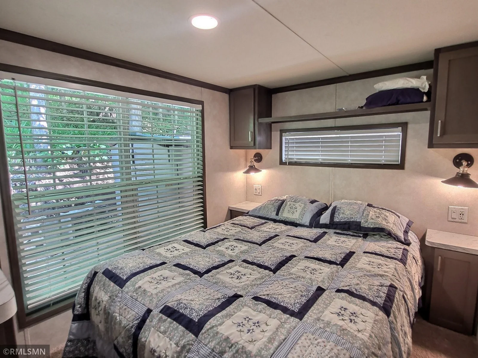 Here is the bedroom with built in shelving and cabinets and located on the back side of the park model.