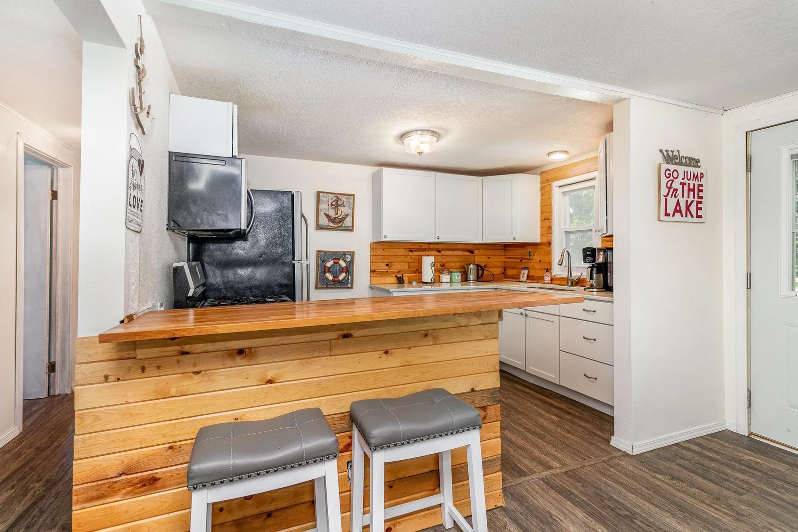 Beautiful kitchen with stainless steel appliances overlooking the lake.