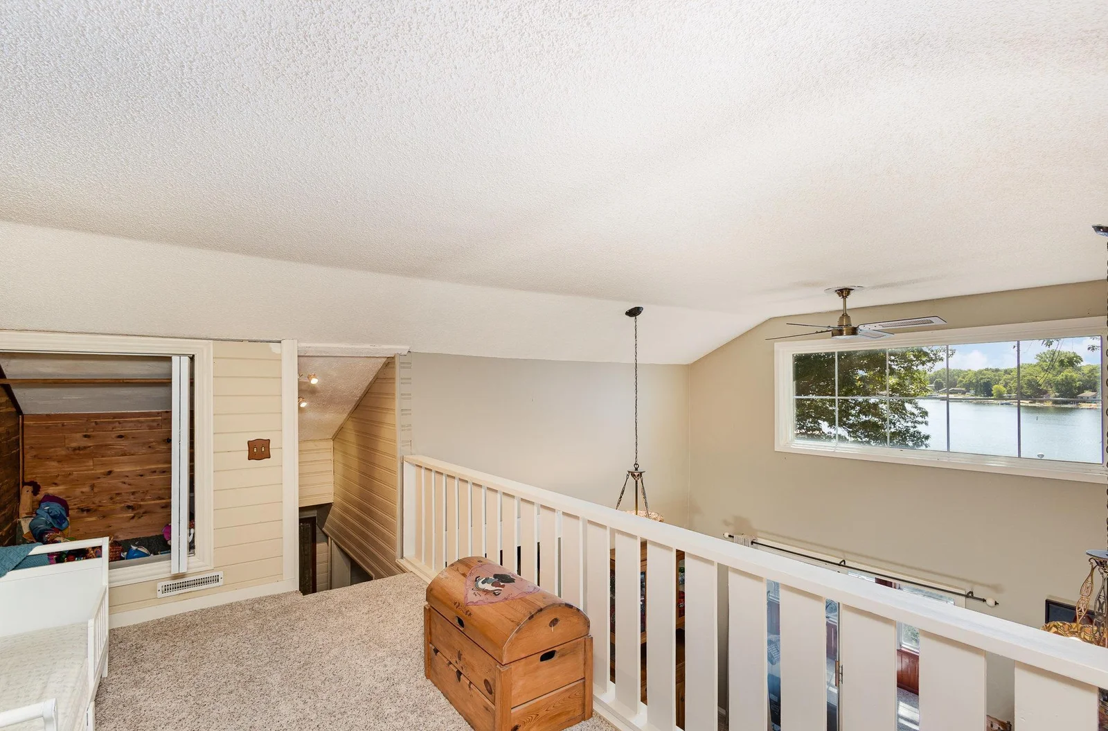 lofted bedroom looks out at the lake