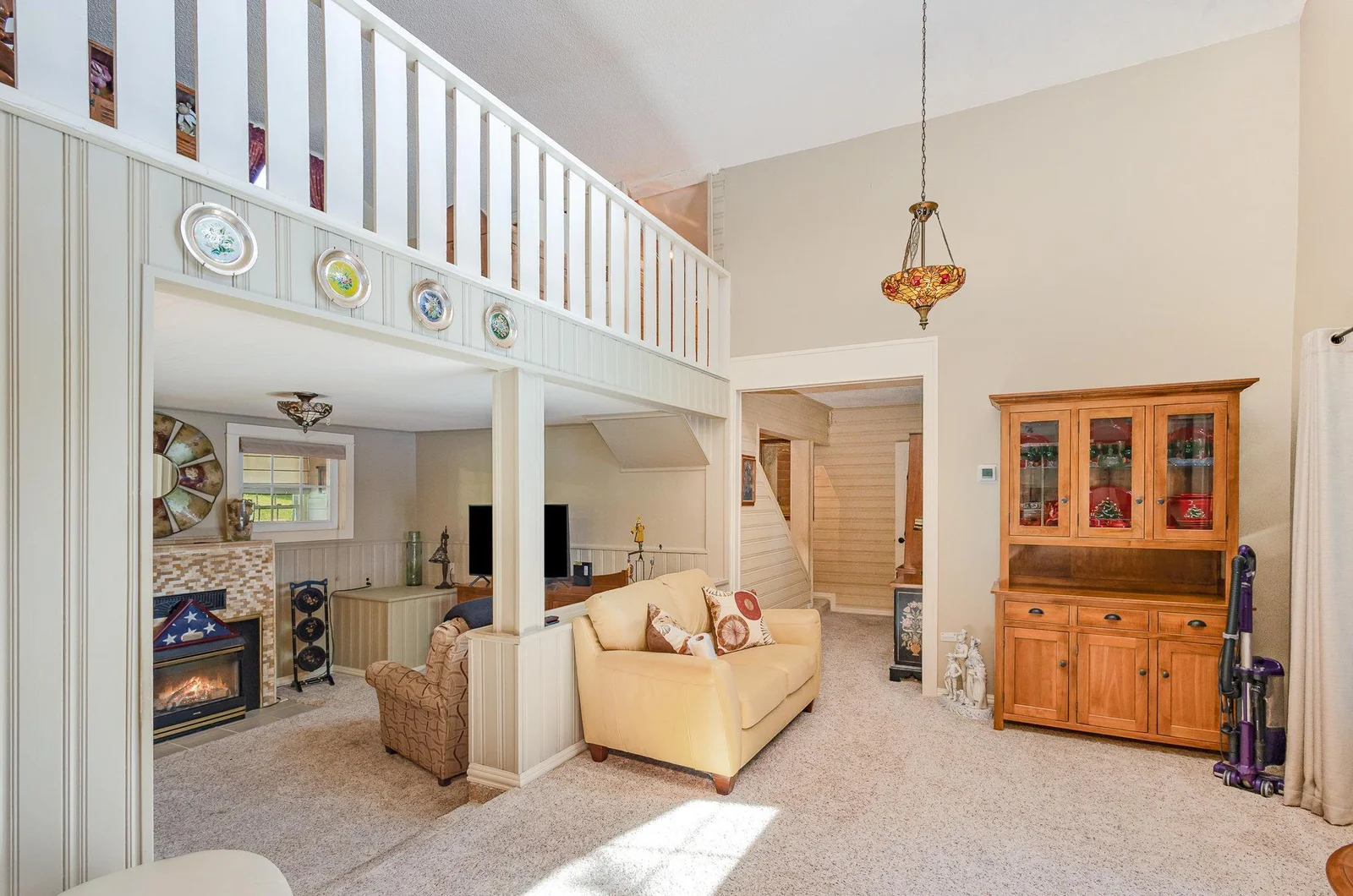 living room with loft above