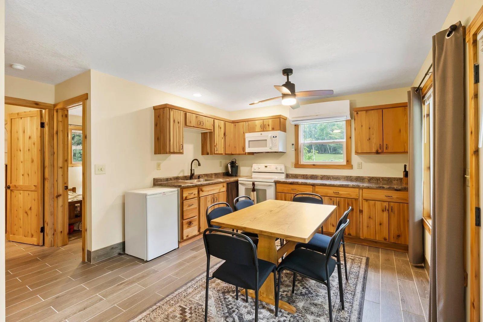 This brand new kitchen was custom designed and built, cabinet doors are constructed of cedar!  Gorgeous ceramic flooring throughout!