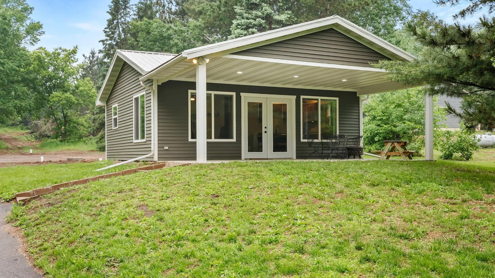 Spacious front covered concrete patio measures 24 x 12! Perfect spot to grab your morning coffee or entertain guests. This patio is built to allow you to add on to this area, making the living room larger if desired.