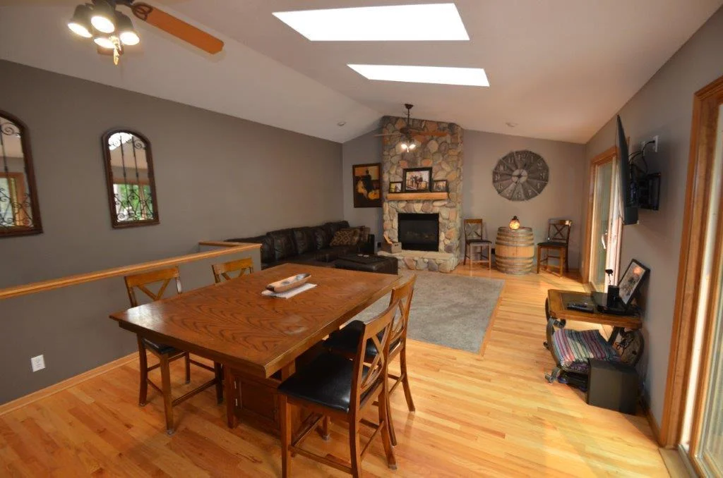 Floor to ceiling gas burning fireplace is the focal point of the room