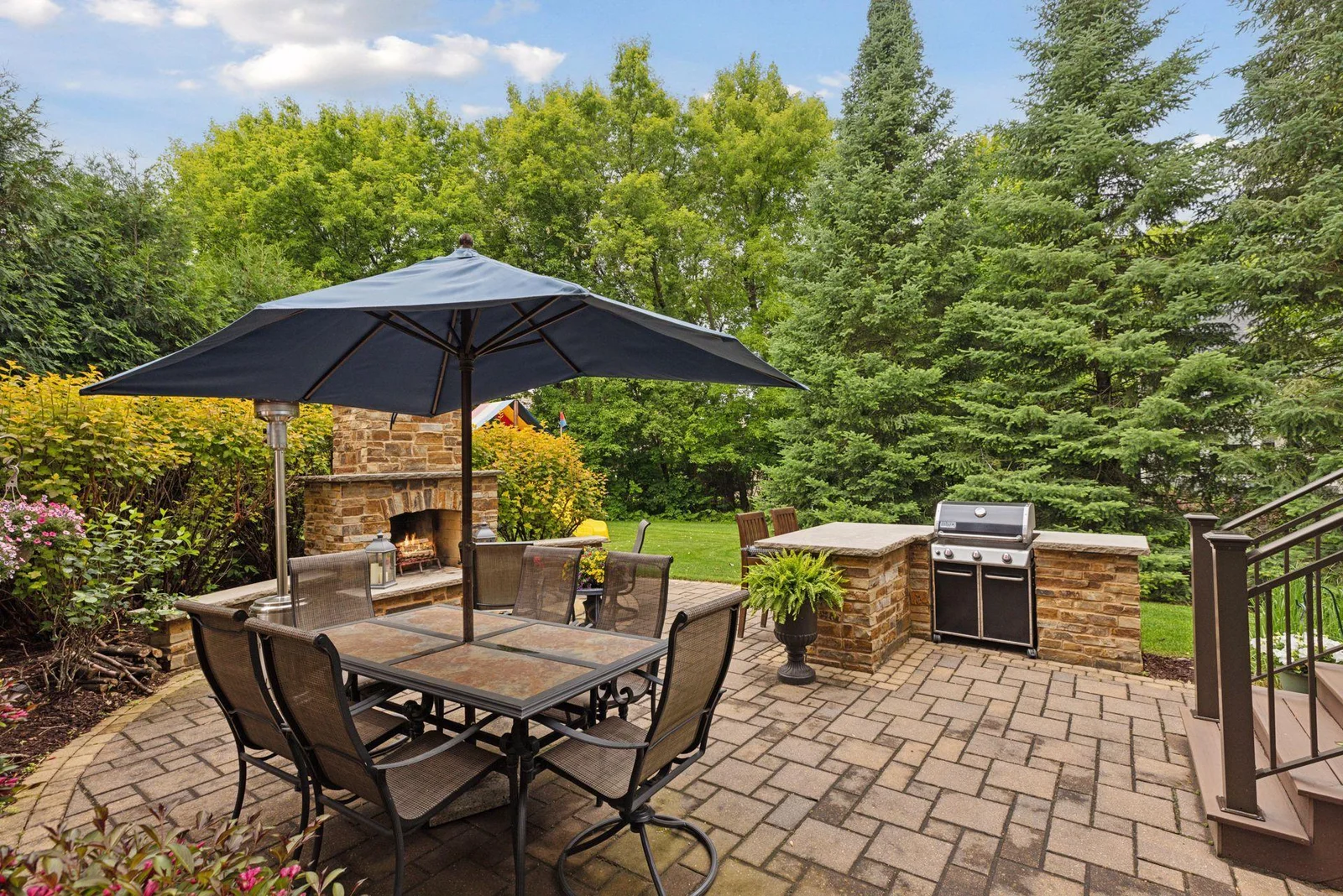 This backyard retreat is an entertainer’s dream, featuring a spacious patio, outdoor kitchen and a stunning stone fireplace.