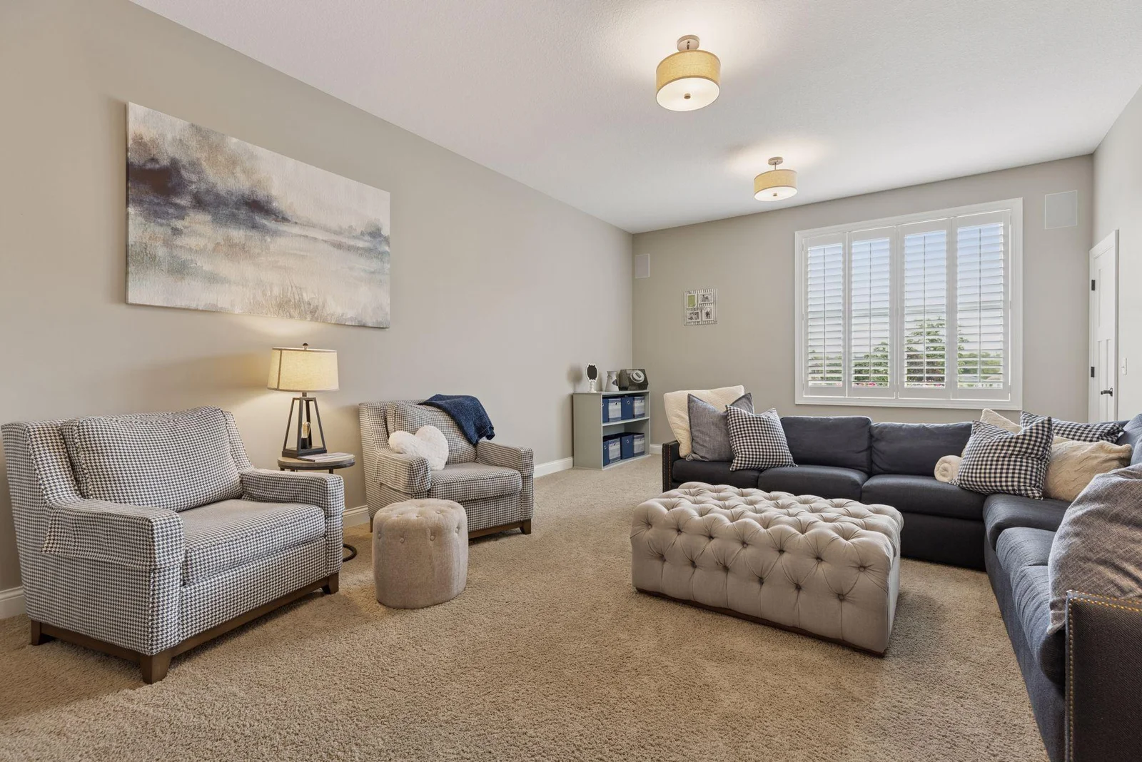 The upper-level family room is spacious and bright, offering the perfect spot to relax, play, or gather with loved ones. Flooded with natural light, it’s a welcoming space that feels open and airy.