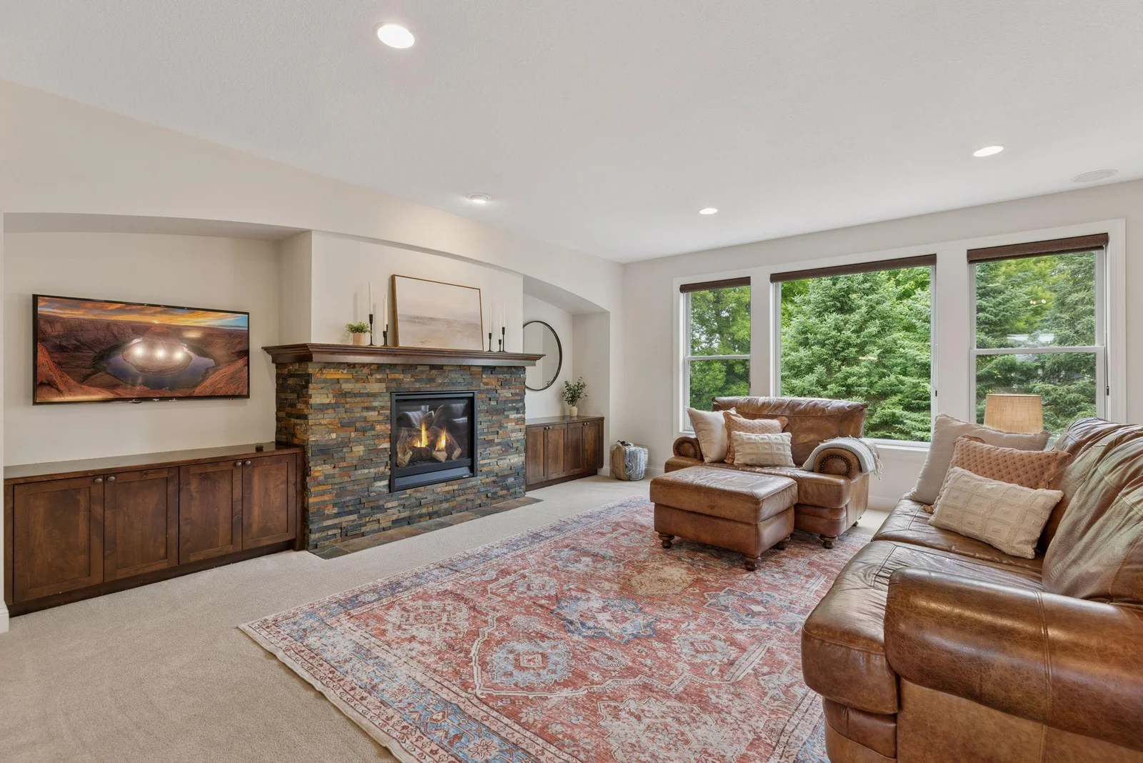 The main-level living room is spacious and bright, with plenty of windows that let in natural light throughout the day. A stylish gas fireplace adds warmth and a cozy focal point, making it ideal for both relaxing and entertaining.