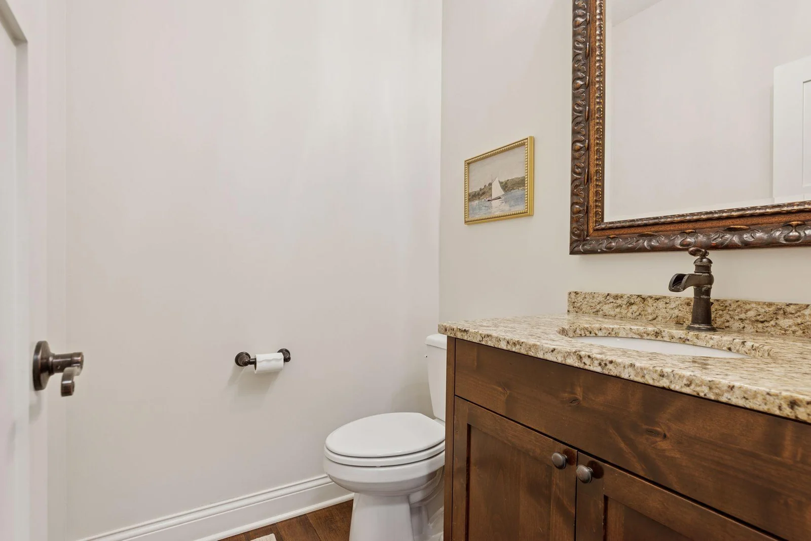 Tucked just off the mudroom is the main floor 1/2 bath.  With its tasteful finishes and easy access from the home's busiest entry point, it's a practical touch for guests and everyday use alike.