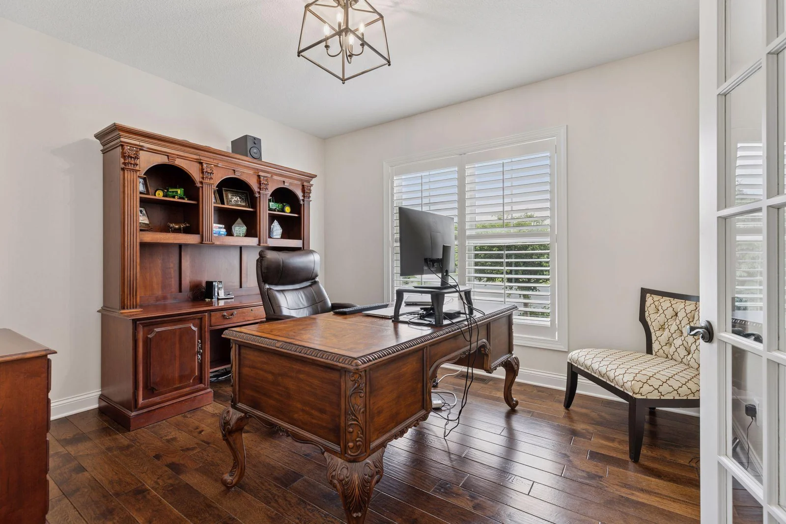 The main floor office offers a quiet, professional space with elegant French doors that provide both privacy and charm.