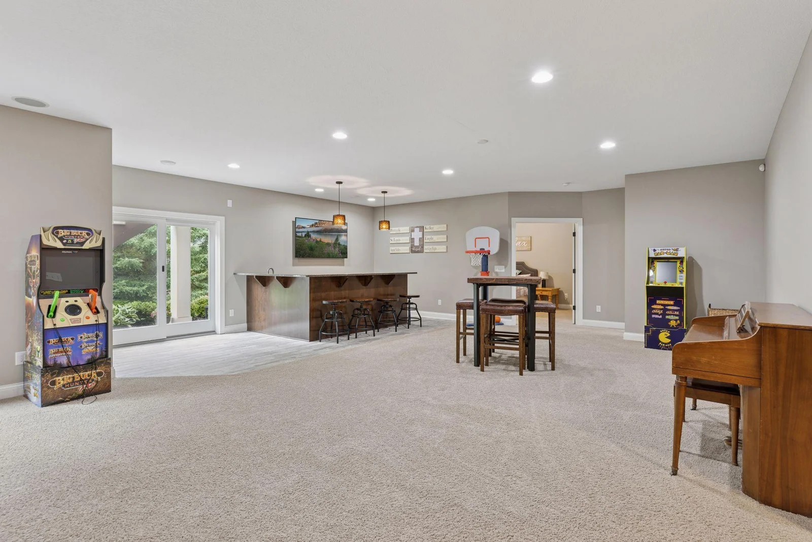 Large windows and walk-out access bring in loads of natural light, seamlessly connecting indoor fun with the backyard retreat. It’s a great setup for entertaining inside and out.