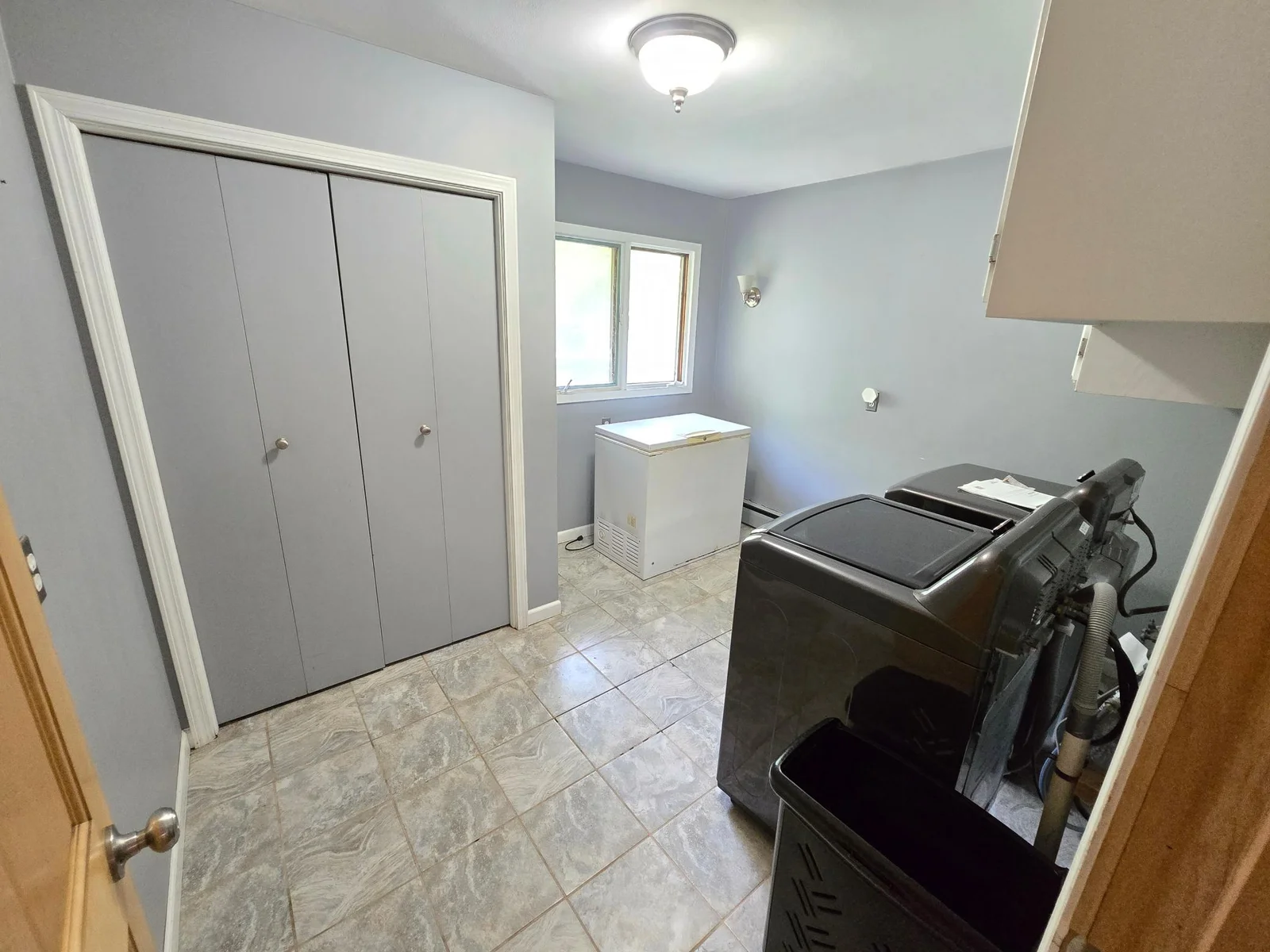 Large laundry room with coat closet right off garage entry