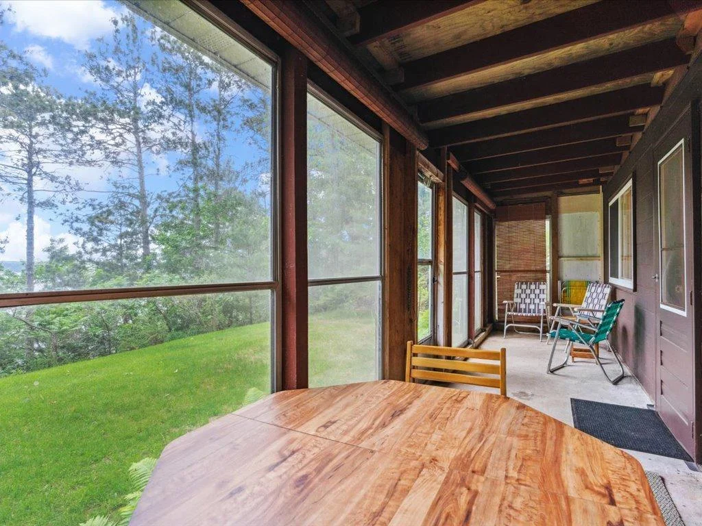 Lower level screened in porch gives access to backyard space