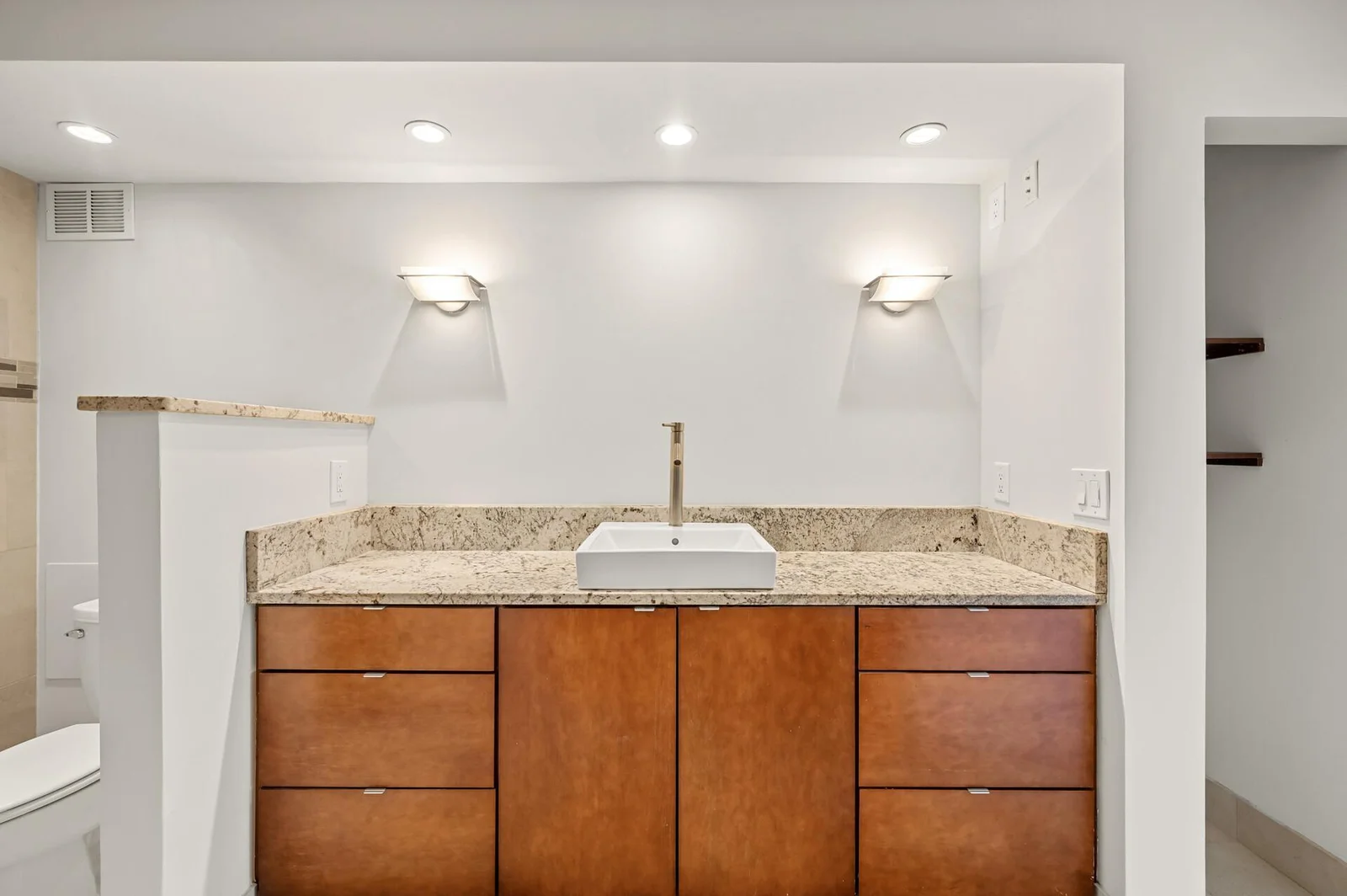 Vanity sink with granite top.
