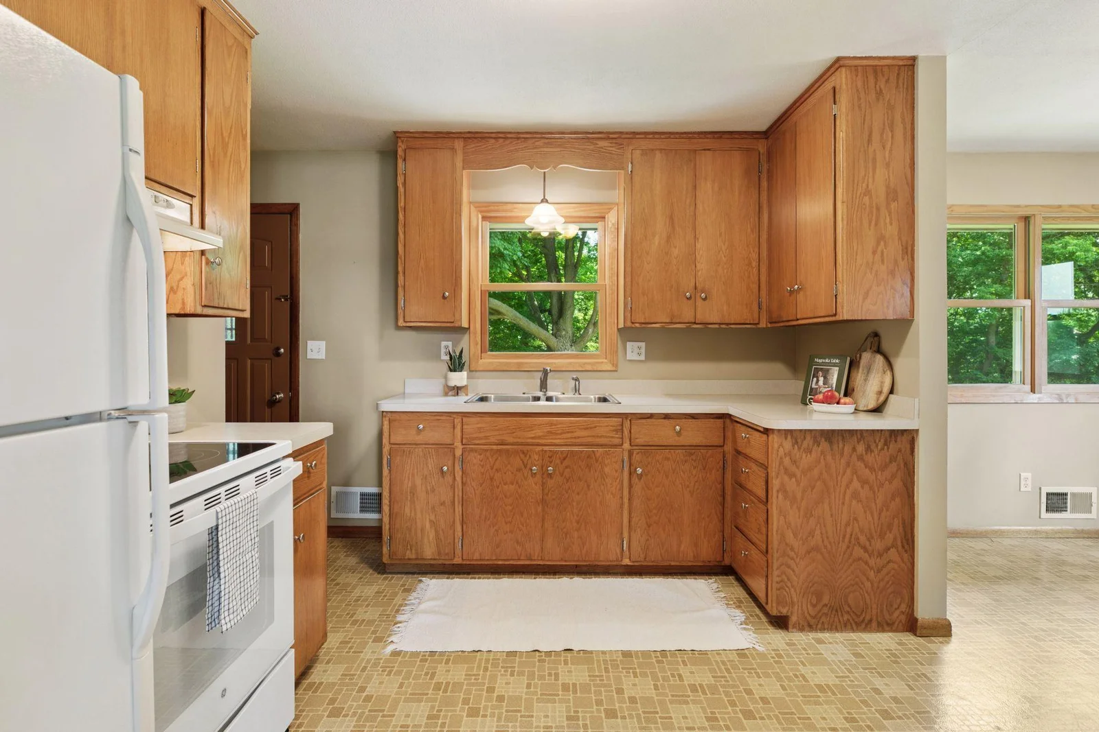Nicely appointed kitchen with good storage and window to backyard.
