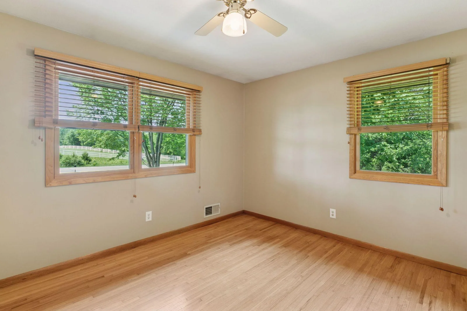 One of three bedrooms on the main floor; ceiling fan, wood blinds and nice size closet!