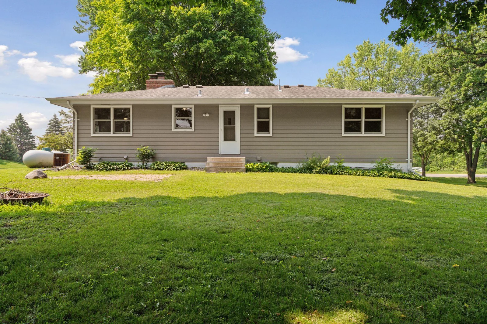 Back of the house with paver patio and firepit