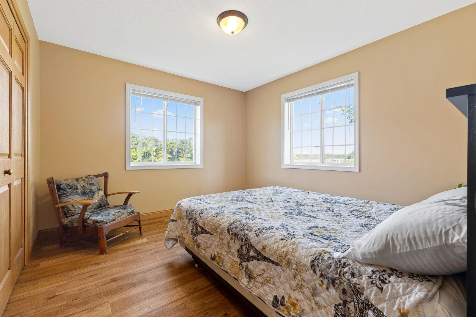 One of the bedrooms on the upper floor of the home.  Nice large windows provide great views of the lake.