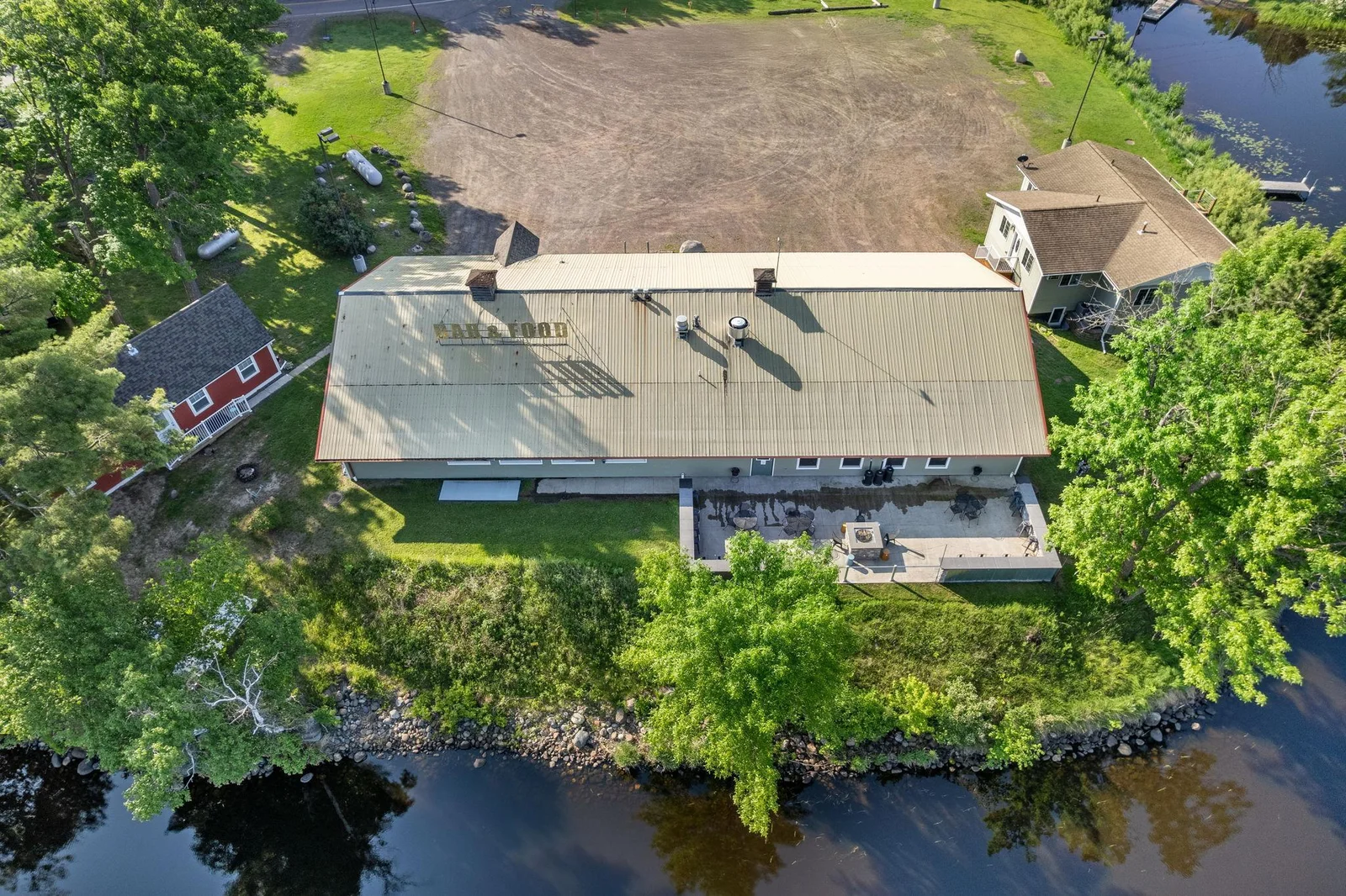 Great view of the building with its metal roof.  The patio is located right on the waters edge.