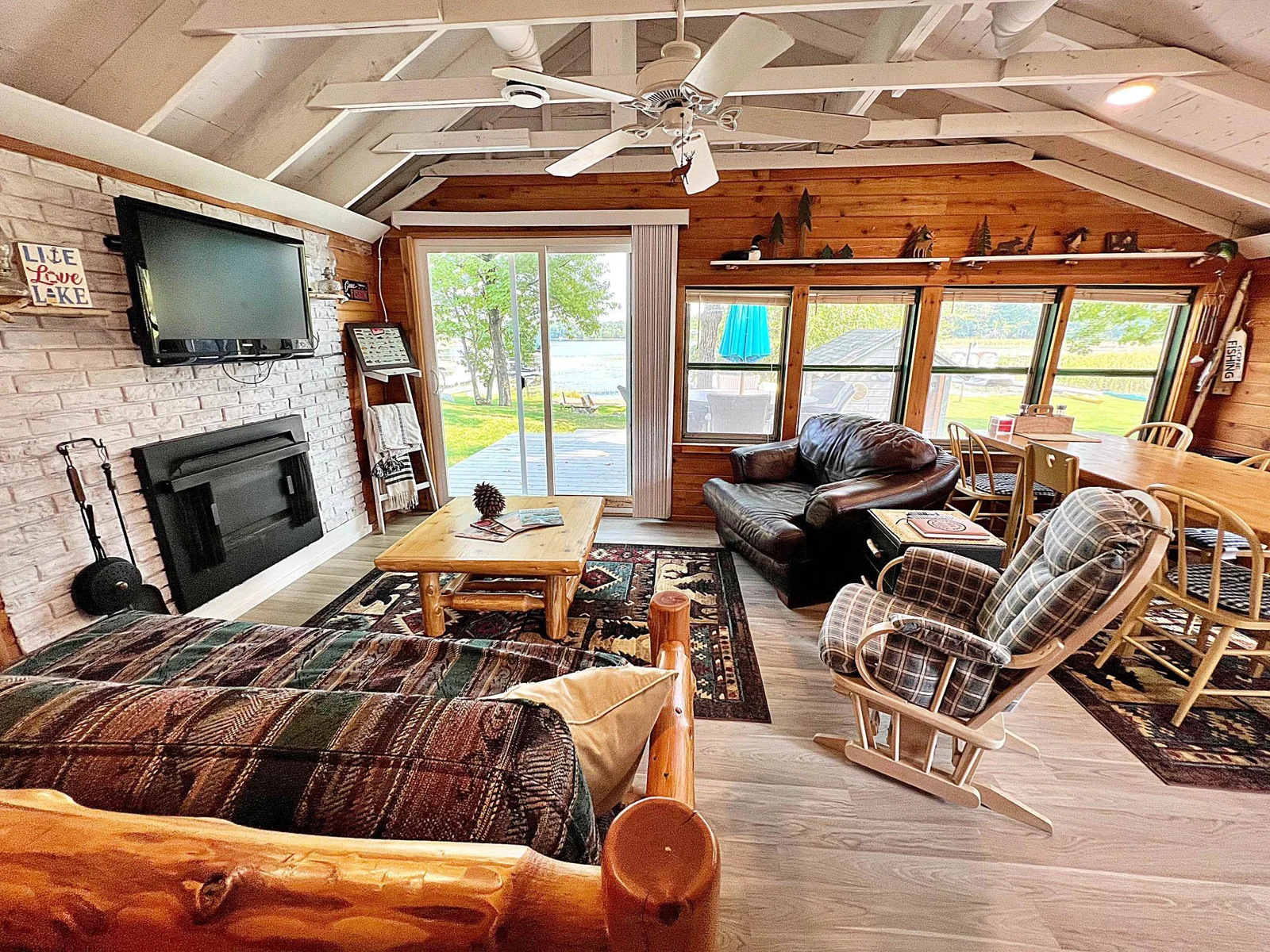 Living space with (non-fuinctioning) fireplace out  to deck with Lake  views 2.jpg