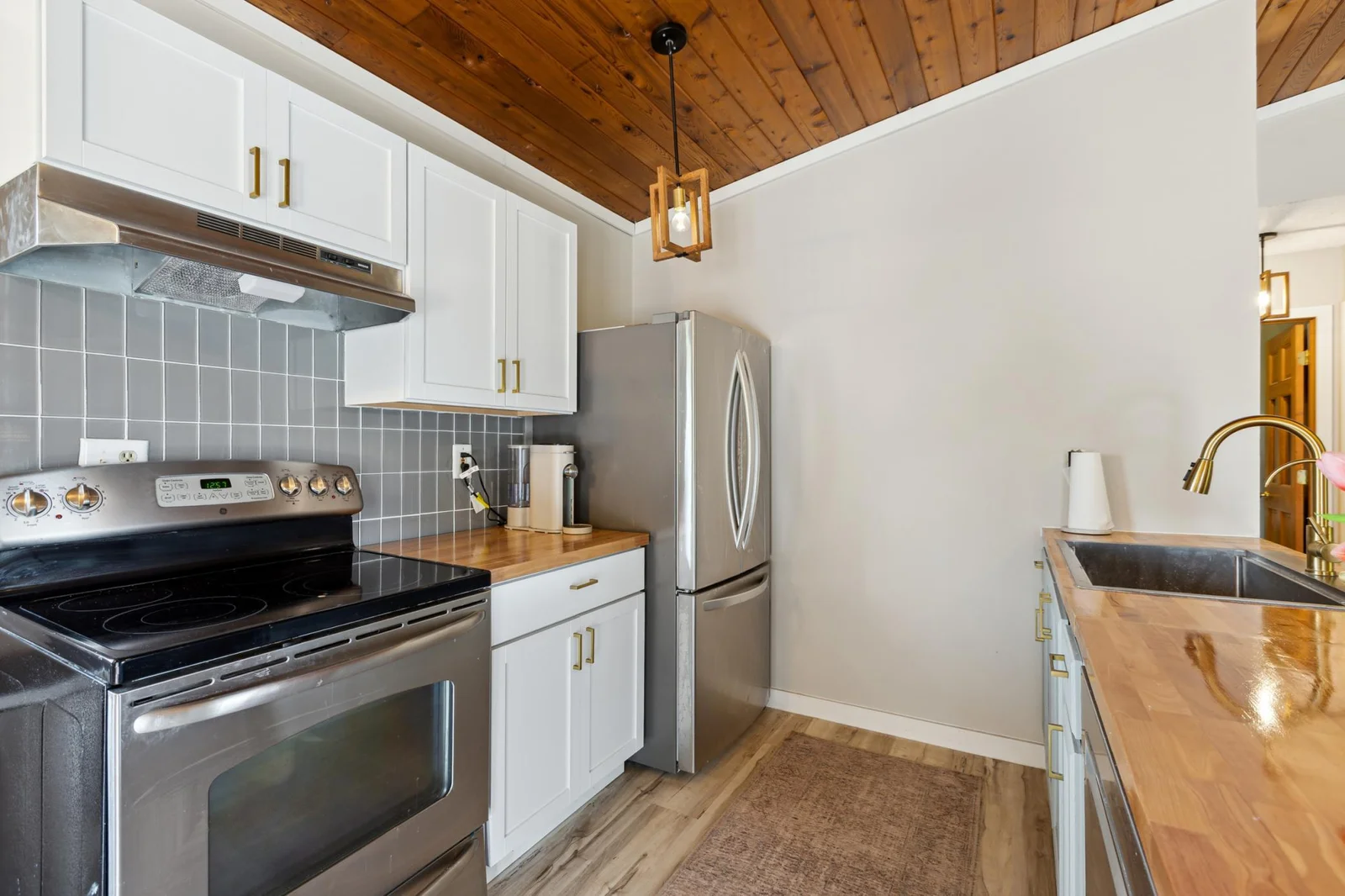 Butcher block counter tops and stainless steel appliances.